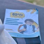 A stack of printed promotional materials highlighting discounts and event info.