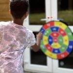 A young boy aiming at the velcro target board_jfif - Copy